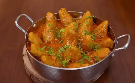 Final curry with gatte and gravy, garnished with kasuri methi.