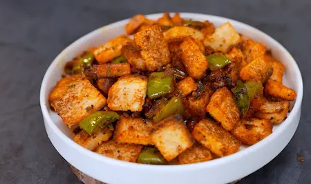 A serving of spicy Bread Chilli garnished with fresh coriander, ready to eat.