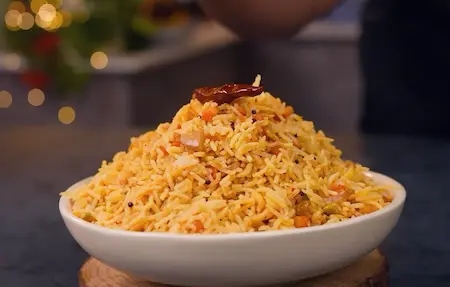 Serve the carrot rice hot with raita, pickle, or papad