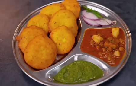 Serving Dhuska with Aloo Chana Sabzi