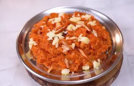 Cooker Wala Gajar Halwa garnished with nuts and saffron strands