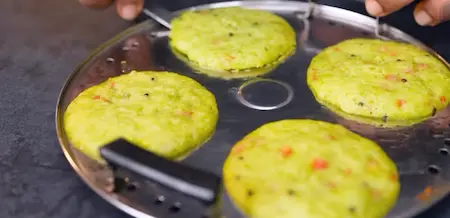 Idlis steaming in the molds