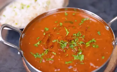 Serving rajma masala with jeera rice and garnishes