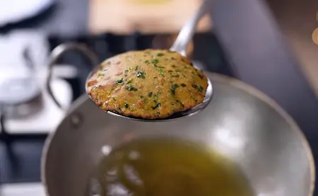 Frying bathua poori