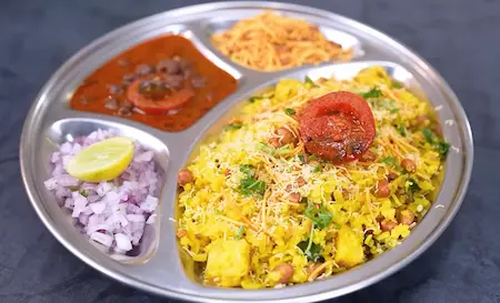 Assembling and serving Nagpur Special Tari Poha with toppings