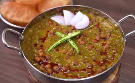 Step 5: serving hot Chana Masala with puris and onion garnish