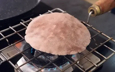 Cooking Mandua Roti on tawa