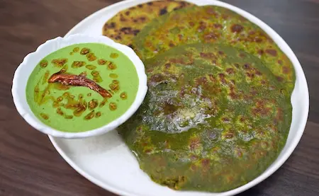 Serve hot matar aur bathua parathas with the bathua raita on the side