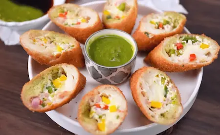 Plated Dahi Ke Sholey recipe served with green chutney and saunth chutney