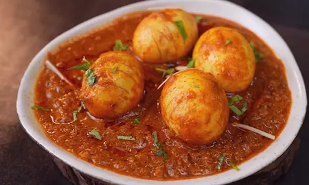 Garnishing Lababdar Dhaba Style Egg Masala Recipe with coriander