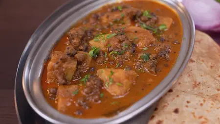 Serving Kala Vatana Usal hot with pav and fresh coriander garnish