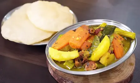 Step 9: Serving Bengali Niramish Jhol hot with luchi and rice