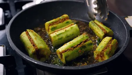 Step 6: Shallow frying stuffed turai on low flame for Bharwa Turai recipe