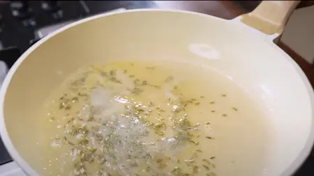 Adding fennel seeds to the hot ghee for Kaddu Ka Halwa.