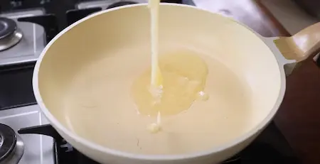 Melting ghee in a heavy-bottomed pan for Kaddu Ka Halwa.