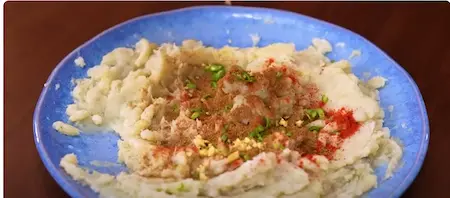 Mashed bananas mixed with spices and ingredients for koftas.