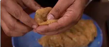 Shaped koftas being prepared with raisins inside.