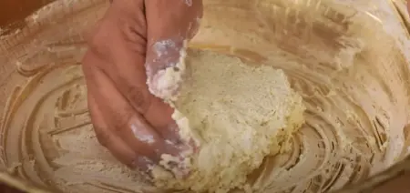  Grating paneer and cheese, mixing with spices for a smooth kebab mixture.