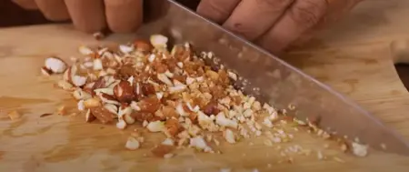 Shallow frying nuts and mixing with spices for the kebab stuffing.