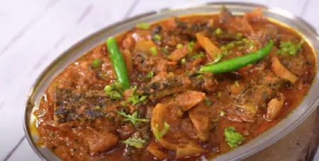  Serving Karela Masala hot with roti, garnished with fresh coriander and a dash of amchur powder.