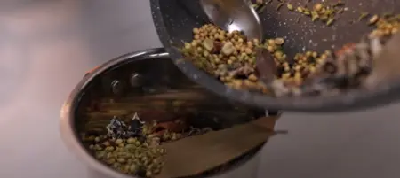 Freshly ground aromatic biryani masala in a white bowl.