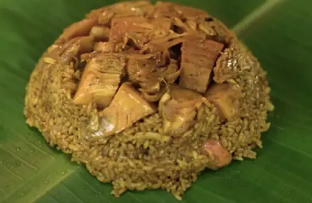 Delicious Jackfruit Donne Biryani served hot on a plate, garnished with fresh herbs.