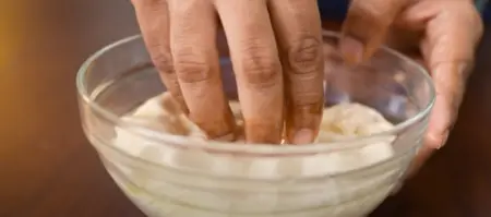 Puran Poli preparation step showing dough being rolled with puran filling