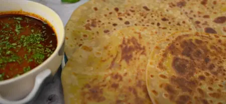 Finished Puran Poli served with Katachi Amti, a traditional Maharashtrian dish.