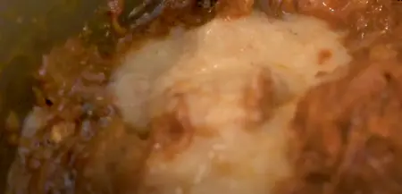 Mutton pieces being sautéed with ginger garlic paste