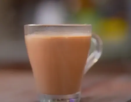 Adrak Elaichi Wali Chai prepared with ginger and cardamom, served hot in a cup.