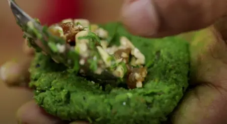 Shaping the Hara Bhara Kebab with cashew stuffing in the center.