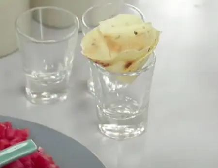 Mini papad being shaped into a cone after cooking.