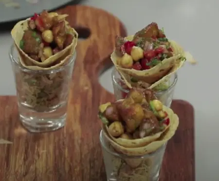  Final assembled Papad Katori Ki Chaat with papad cone on top of a shot glass filled with salad.