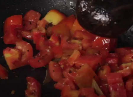 Chopped tomatoes added to the spice mixture for Sev Tamatar Nu Shak.