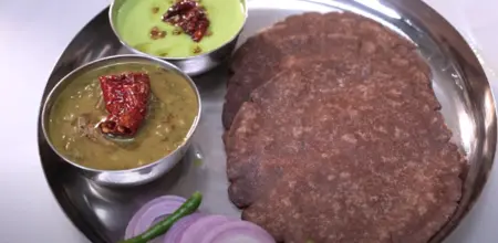 Hot Dal Saag served with rice and garnished with fresh coriander leaves.