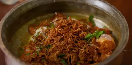  Golden brown fried onions cooling on a paper towel.