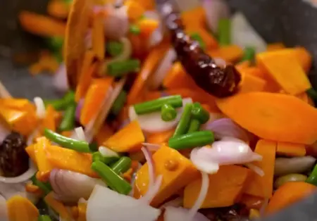 Chopped vegetables for kebab mixture including carrot, beans, cauliflower, and pumpkin.