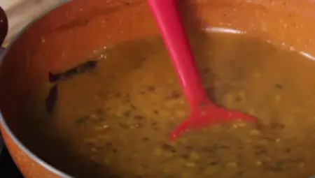 Mixed dals being pressure-cooked with turmeric and salt.