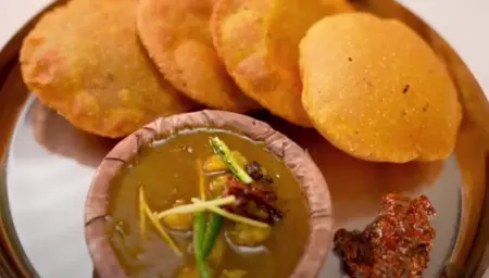 Rolling out and frying the puris.