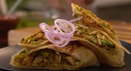 Crispy Kolkata Style Chicken Kathi Roll served with Laccha onion on the side.