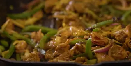 Onion, capsicum, and cabbage sautéed with spices for the stuffing.