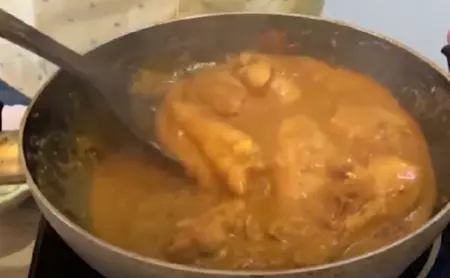 Sautéing onions until golden brown for Chicken Biryani.