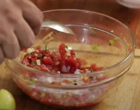 Mixing roasted tomatoes and garlic for chutney.