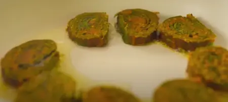 Shallow frying sliced Patra rolls until golden brown.