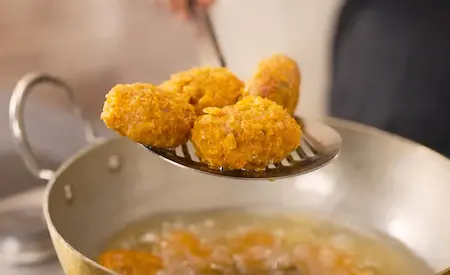 Crispy golden-brown soya nuggets being fried in hot oil