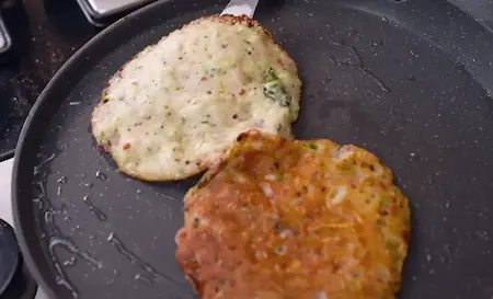 Cooking Lauki Chila on a non-stick pan