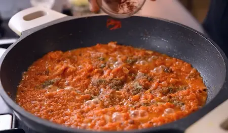 Khoya, saffron, and cardamom added to enhance Gajar Halwa flavor