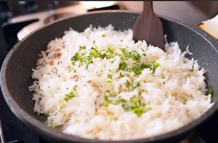 Preparing jeera rice to serve with rajma masala