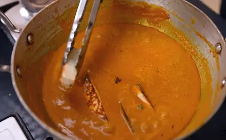 Adding paneer to the korma gravy and simmering with cream