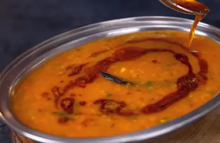 Serving masoor dal tadka in bowl